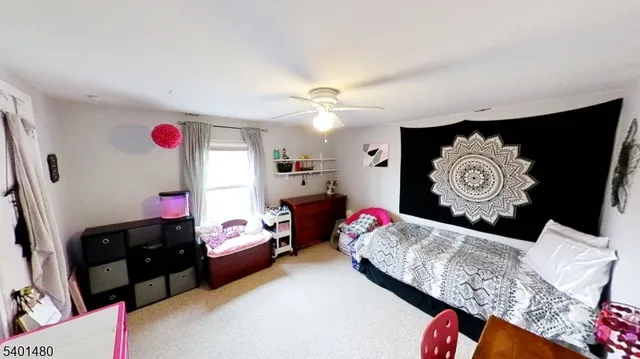 a bedroom with bed and a chandelier