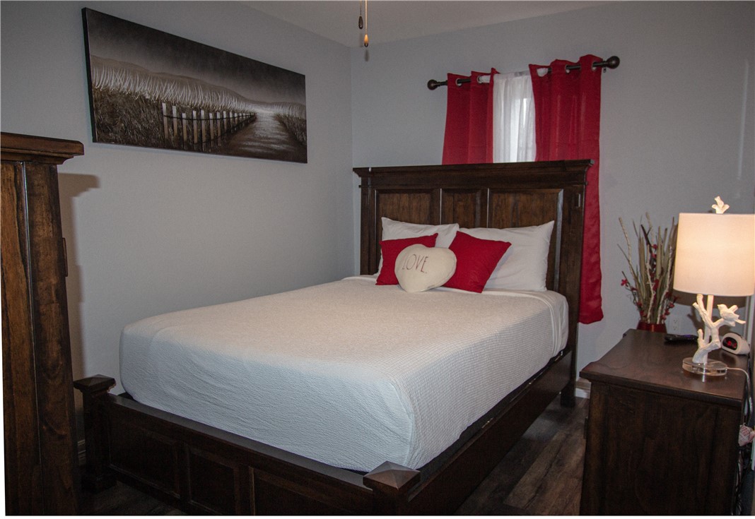 1505 Dewitt Street Corpus Christi, TX 78418 - Photo 17 of 18 a bedroom with a bed and a night stand