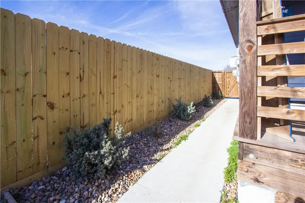 a view of a back yard with a wooden fence