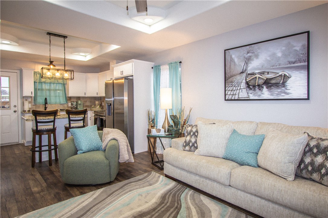 1505 Dewitt Street Corpus Christi, TX 78418 - Photo 10 of 18 a living room with furniture and a chandelier