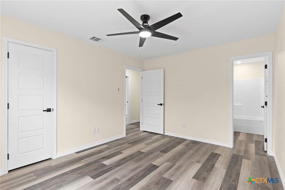 5222 Rose Gdn Loop Killeen, TX 76542 - Photo 11 of 25 a view of a livingroom with wooden floor and a ceiling fan