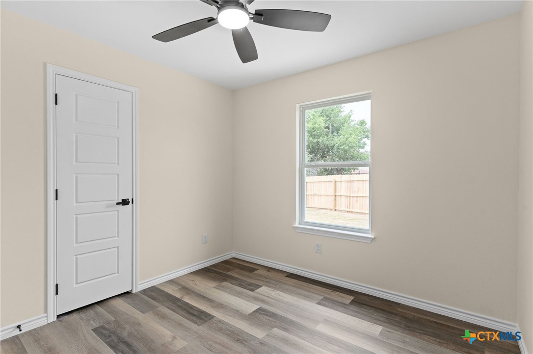 5222 Rose Gdn Loop Killeen, TX 76542 - Photo 15 of 25 a view of an empty room with a window and wooden floor