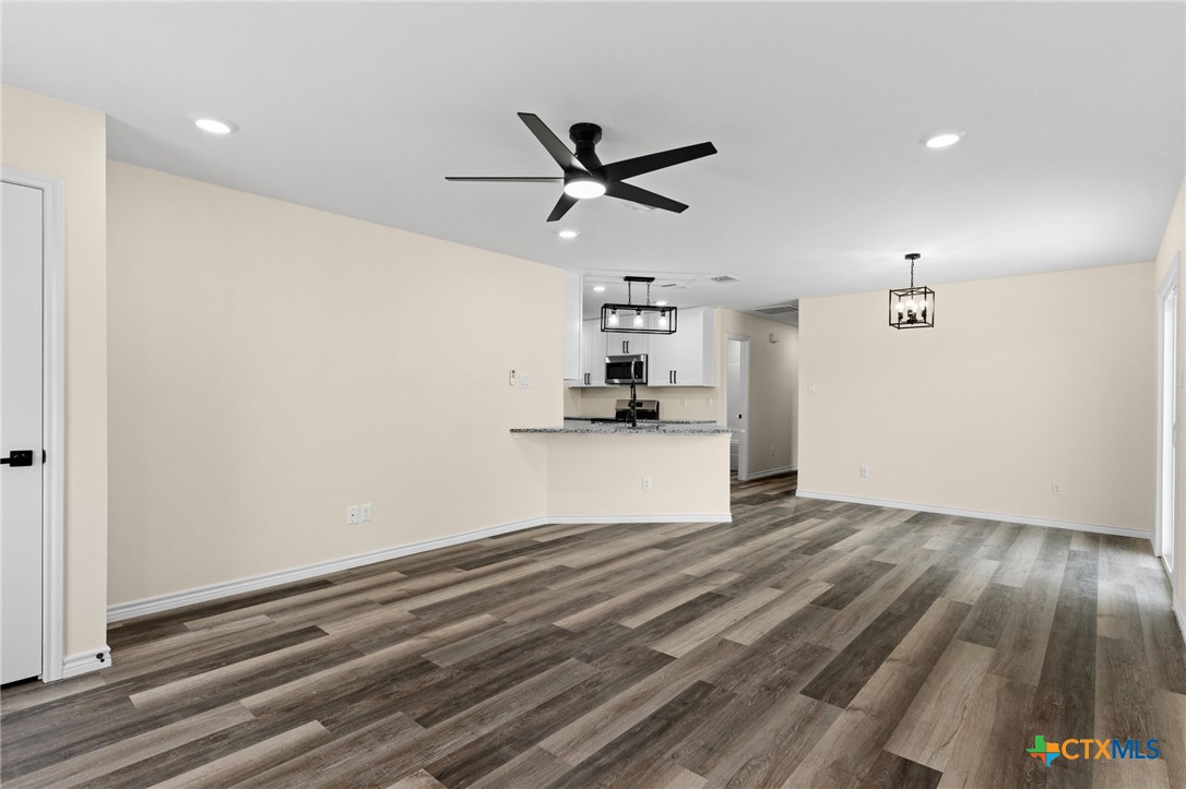 5222 Rose Gdn Loop Killeen, TX 76542 - Photo 2 of 25 a view of empty room with wooden floor and ceiling fan