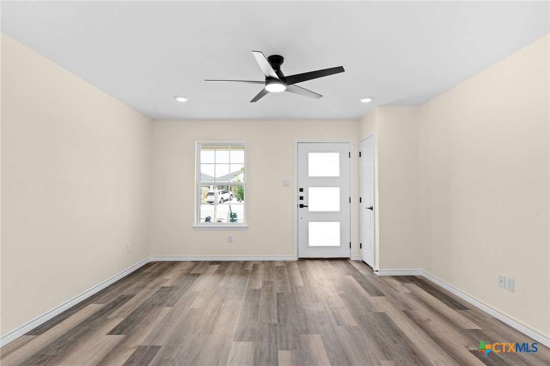 5222 Rose Gdn Loop Killeen, TX 76542 - Photo 3 of 25 an empty room with wooden floor and windows