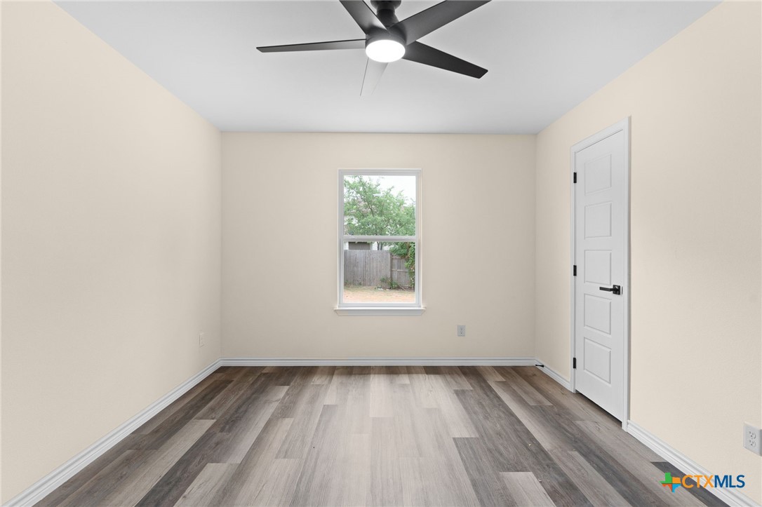 5222 Rose Gdn Loop Killeen, TX 76542 - Photo 4 of 25 a view of an empty room with wooden floor and a window