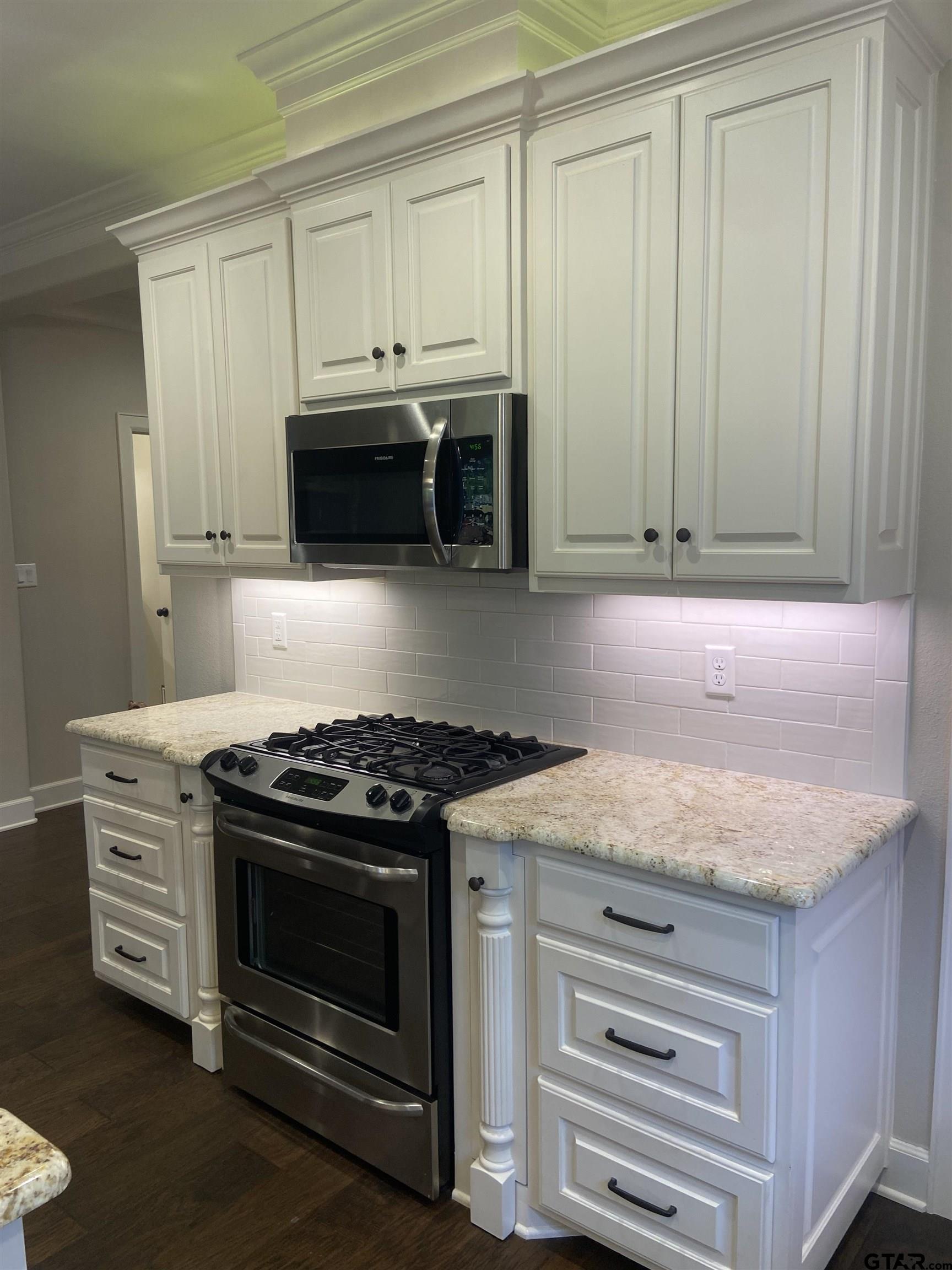 16864 Easy Street Flint, TX 75762 - Photo 14 of 37 a kitchen with granite countertop white cabinets and stainless steel appliances