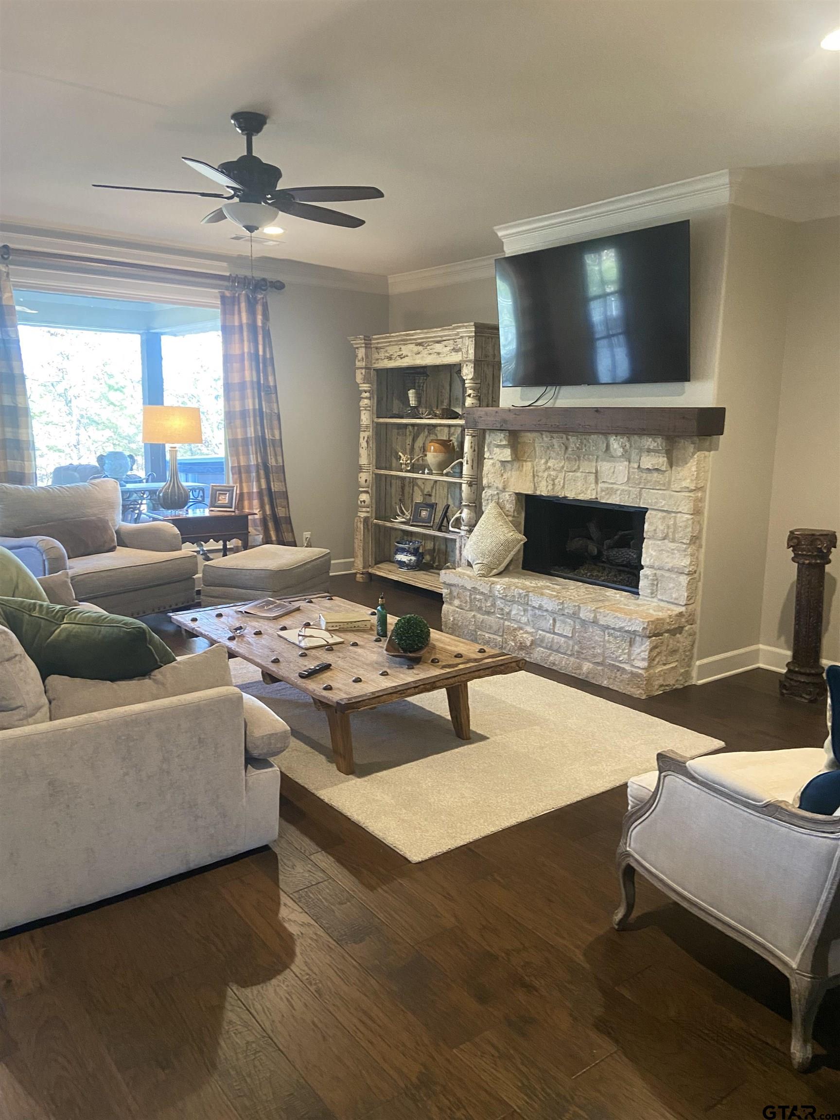 16864 Easy Street Flint, TX 75762 - Photo 18 of 37 a living room with furniture a fireplace and a flat screen tv