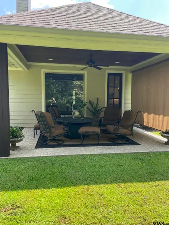 a view of a hallway with wooden floor and furniture