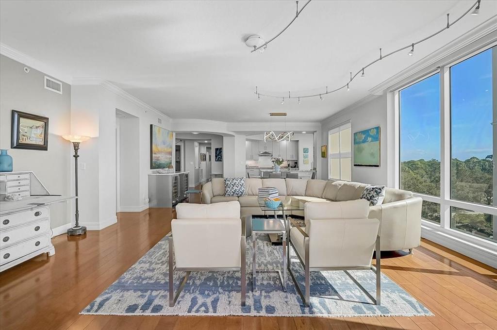 409 North Point Road, Unit 601 Osprey, FL 34229 - Photo 11 of 63 a living room with furniture a large window and wooden floor