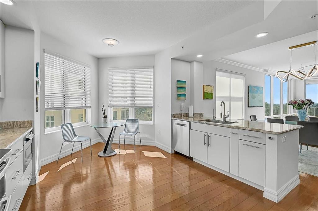 409 North Point Road, Unit 601 Osprey, FL 34229 - Photo 15 of 63 a large white kitchen with granite countertop a stove and white cabinets