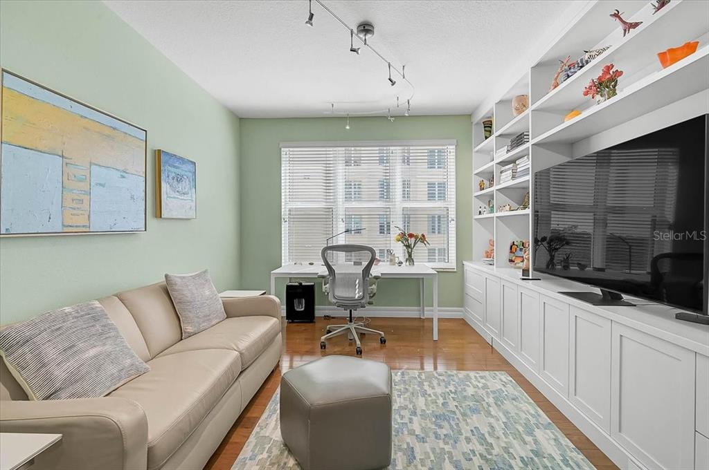 409 North Point Road, Unit 601 Osprey, FL 34229 - Photo 18 of 63 a living room with furniture and a flat screen tv