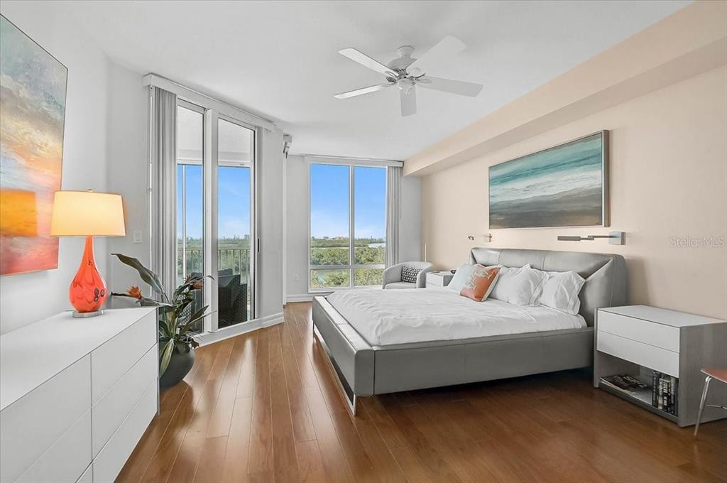 409 North Point Road, Unit 601 Osprey, FL 34229 - Photo 19 of 63 a bedroom with a bed and a flat screen tv