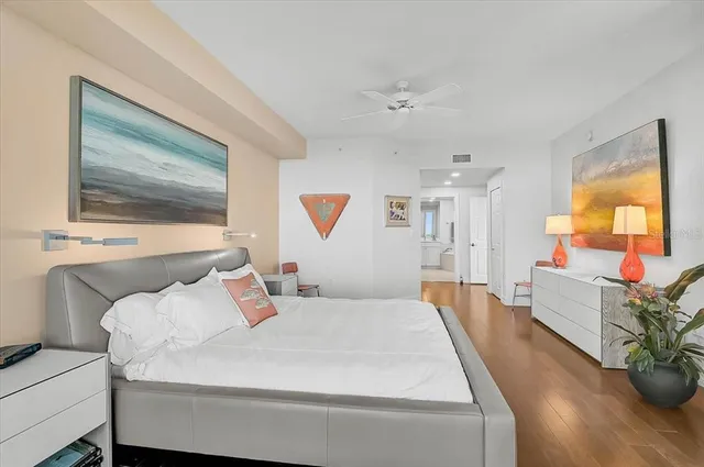 a living room with furniture a flat screen tv and a floor to ceiling window