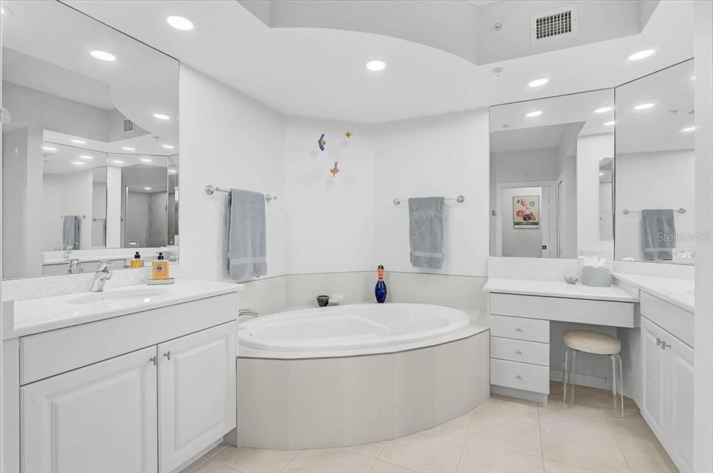 409 North Point Road, Unit 601 Osprey, FL 34229 - Photo 22 of 63 a bathroom with a sink a large mirror and a bathtub