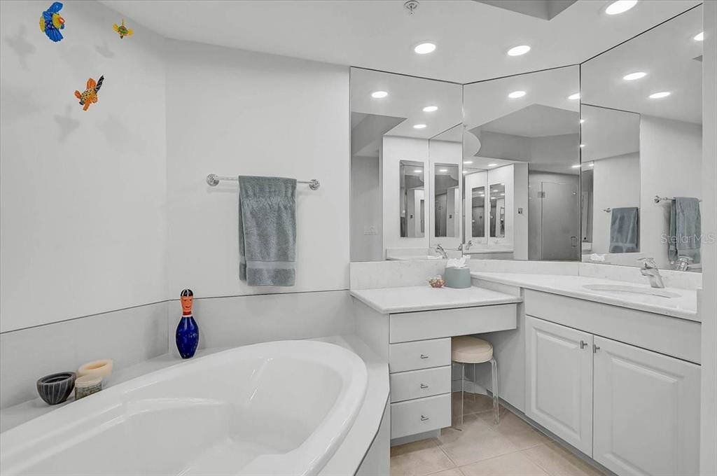 409 North Point Road, Unit 601 Osprey, FL 34229 - Photo 23 of 63 a bathroom with a tub sink and mirror