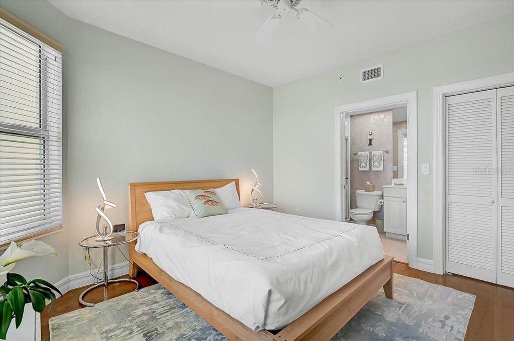 409 North Point Road, Unit 601 Osprey, FL 34229 - Photo 27 of 63 a bedroom with a bed and a table