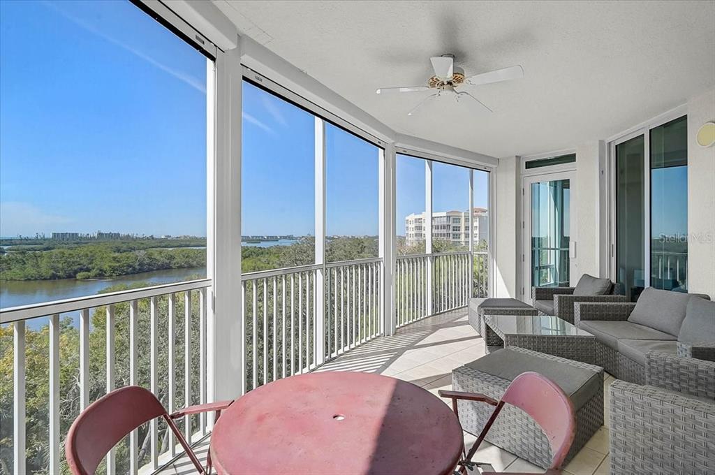 409 North Point Road, Unit 601 Osprey, FL 34229 - Photo 31 of 63 a balcony with table and chairs
