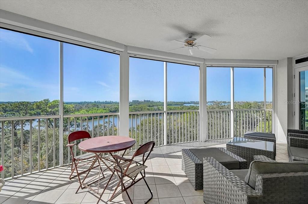 409 North Point Road, Unit 601 Osprey, FL 34229 - Photo 32 of 63 a view of a living room and floor to ceiling window