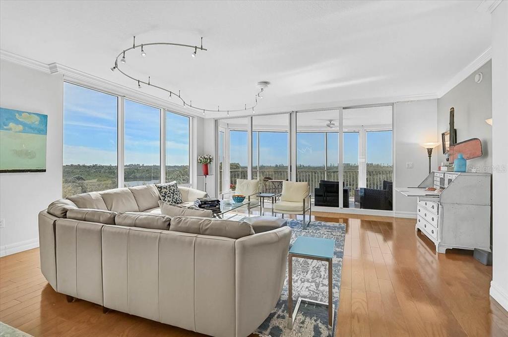 409 North Point Road, Unit 601 Osprey, FL 34229 - Photo 8 of 63 a living room with furniture kitchen view and large windows