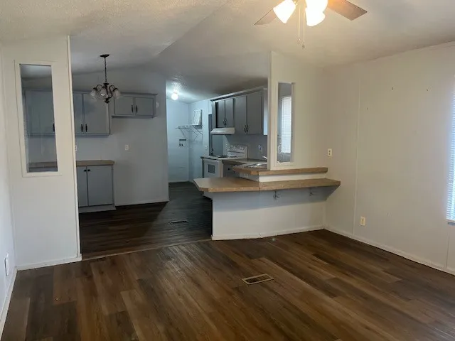 a kitchen with kitchen island a stove and a refrigerator