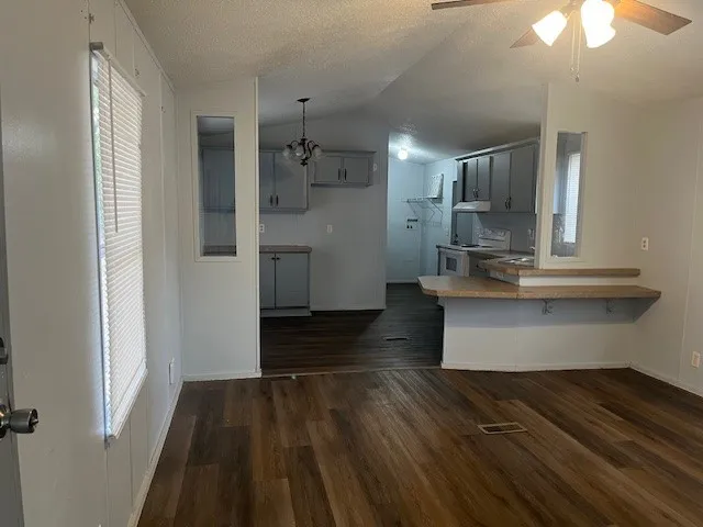 a view of kitchen with sink microwave and refrigerator