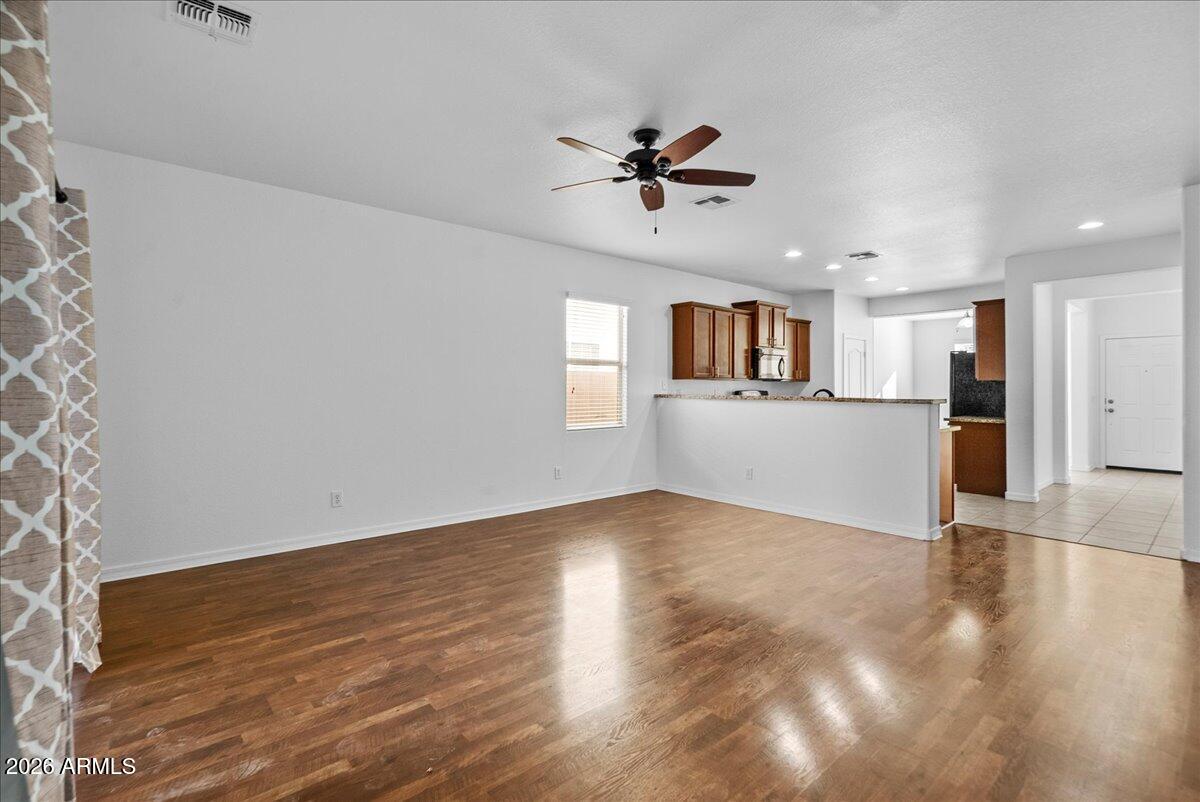 4366 West White Canyon Road San Tan Valley, AZ 85144 - Photo 13 of 35 a view of a big room with wooden floor and windows