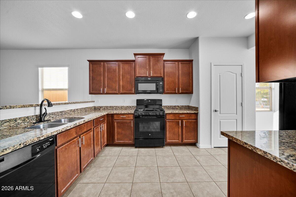 4366 West White Canyon Road San Tan Valley, AZ 85144 - Photo 14 of 35 a kitchen with stainless steel appliances granite countertop a stove top oven sink and cabinets