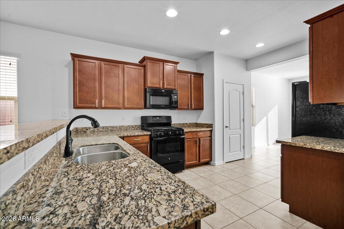 4366 West White Canyon Road San Tan Valley, AZ 85144 - Photo 15 of 35 a kitchen with stainless steel appliances granite countertop a stove a sink and a refrigerator