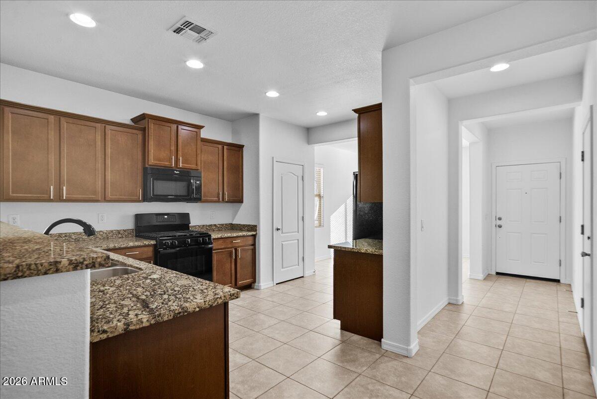4366 West White Canyon Road San Tan Valley, AZ 85144 - Photo 16 of 35 a kitchen with stainless steel appliances granite countertop a refrigerator and a stove top oven