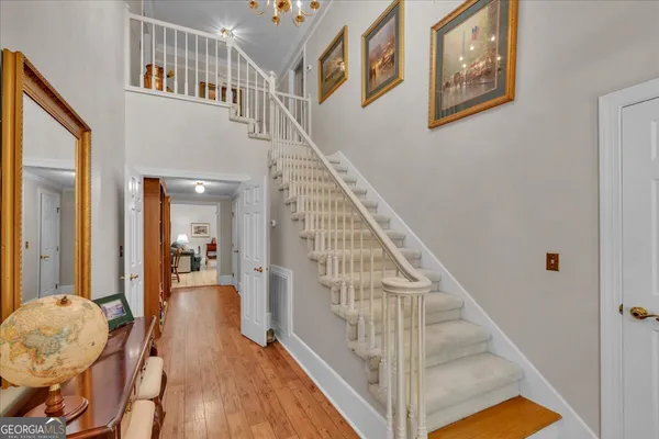 a dining room with furniture a large window and a chandelier