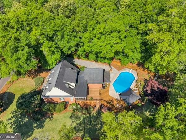 an aerial view of a house with swimming pool and garden view