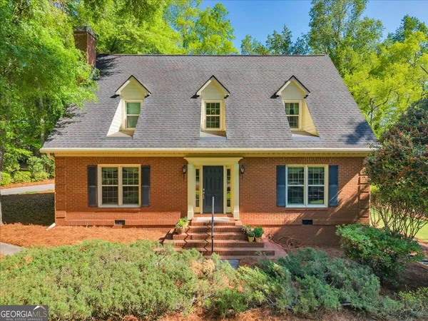 a front view of a house with a yard table and chairs