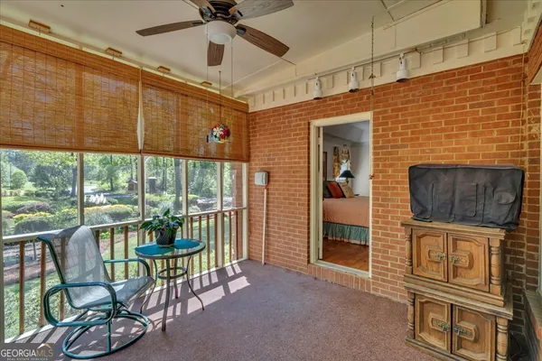 a backyard of a house with table and chairs