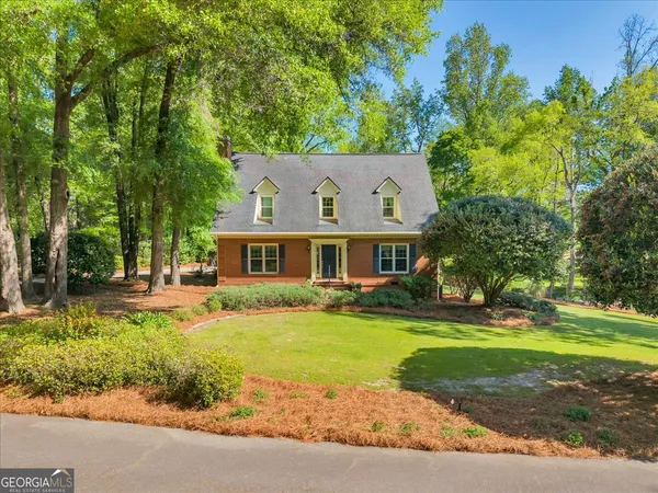 a front view of house with yard and green space