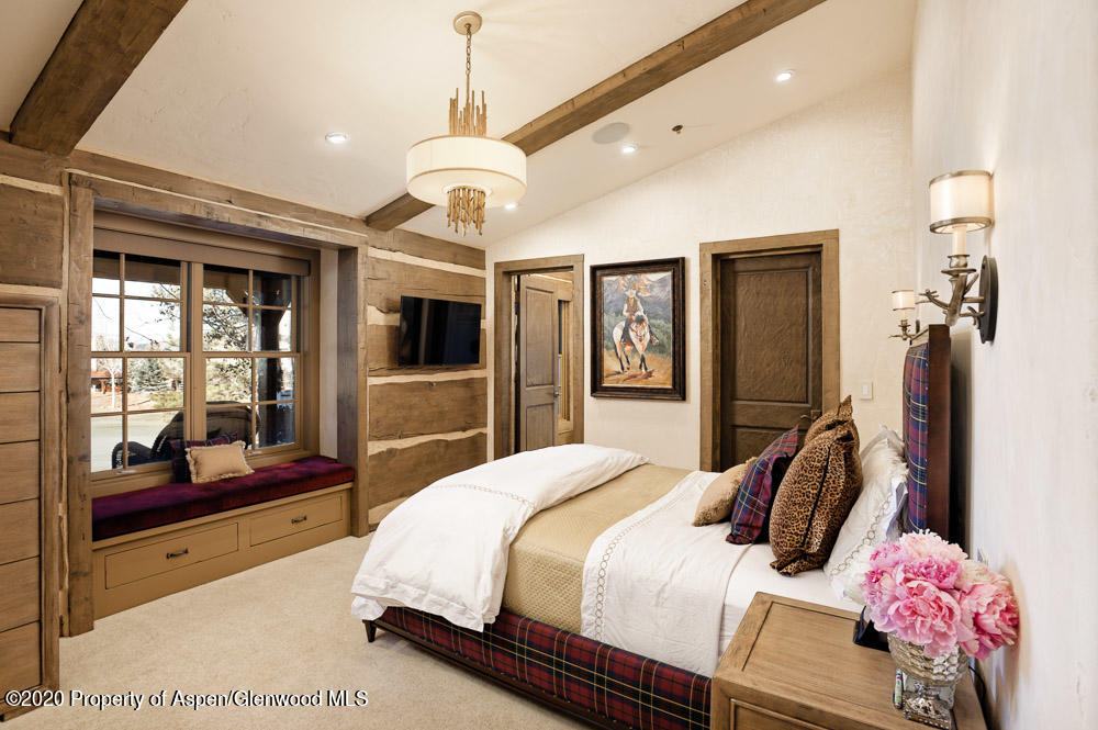 14 Arbaney Ranch Road Basalt, CO 81621 - Photo 12 of 29 a bedroom with a bed flat screen tv and dresser