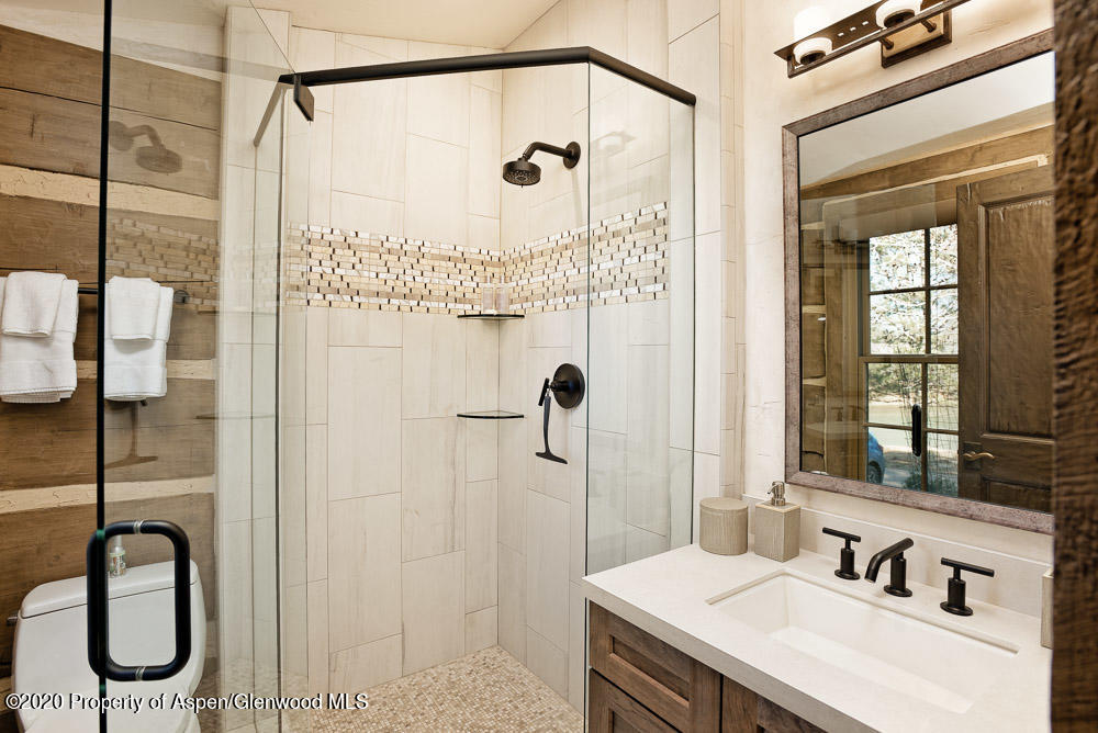 14 Arbaney Ranch Road Basalt, CO 81621 - Photo 13 of 29 a bathroom with a granite countertop sink a toilet and shower