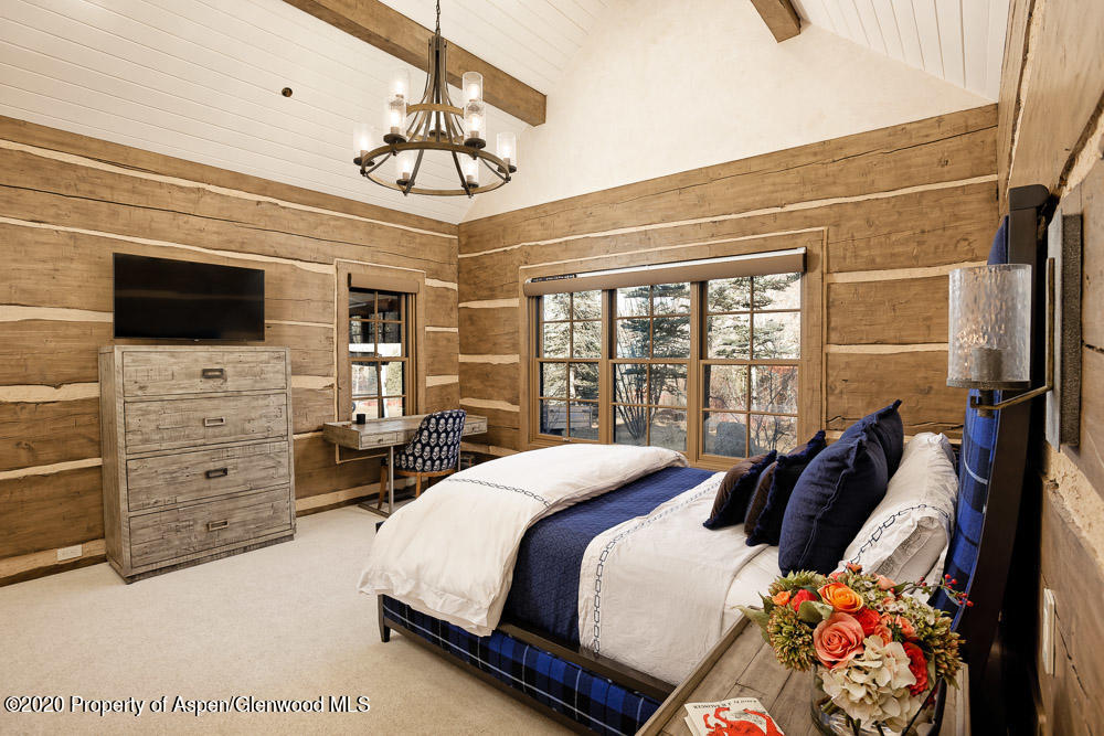 14 Arbaney Ranch Road Basalt, CO 81621 - Photo 14 of 29 a bedroom with a bed a flat screen tv and a dresser