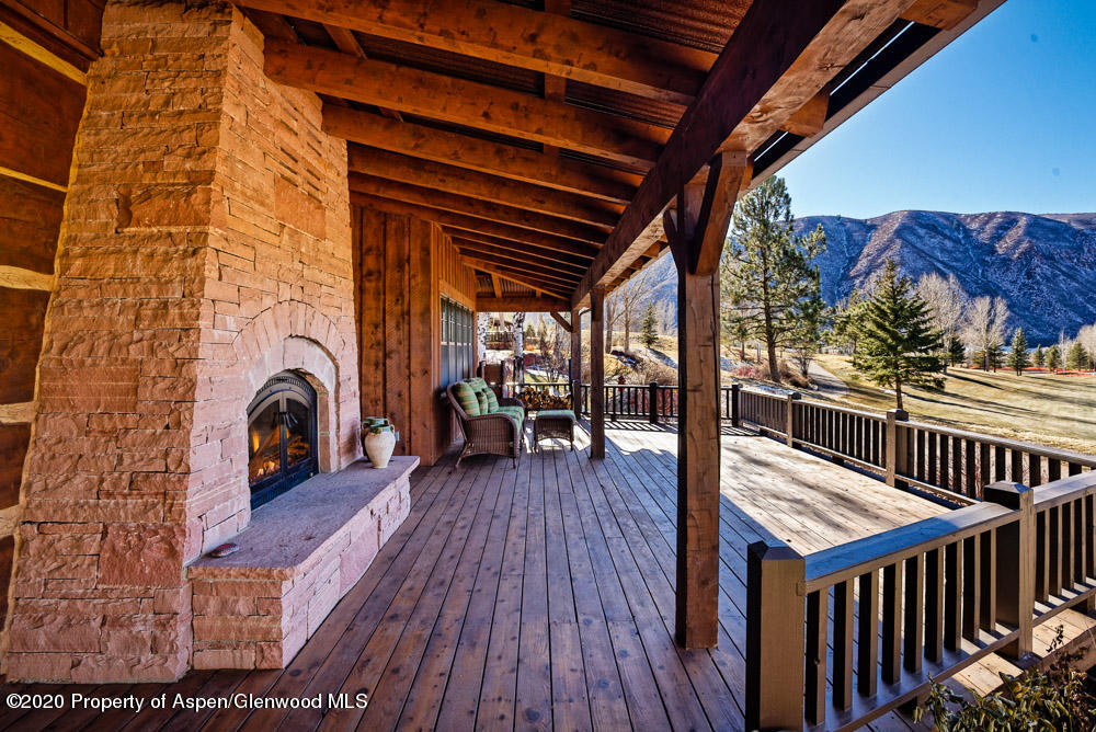 14 Arbaney Ranch Road Basalt, CO 81621 - Photo 25 of 29 a view of a roof deck with table and chairs a barbeque with wooden floor and fence