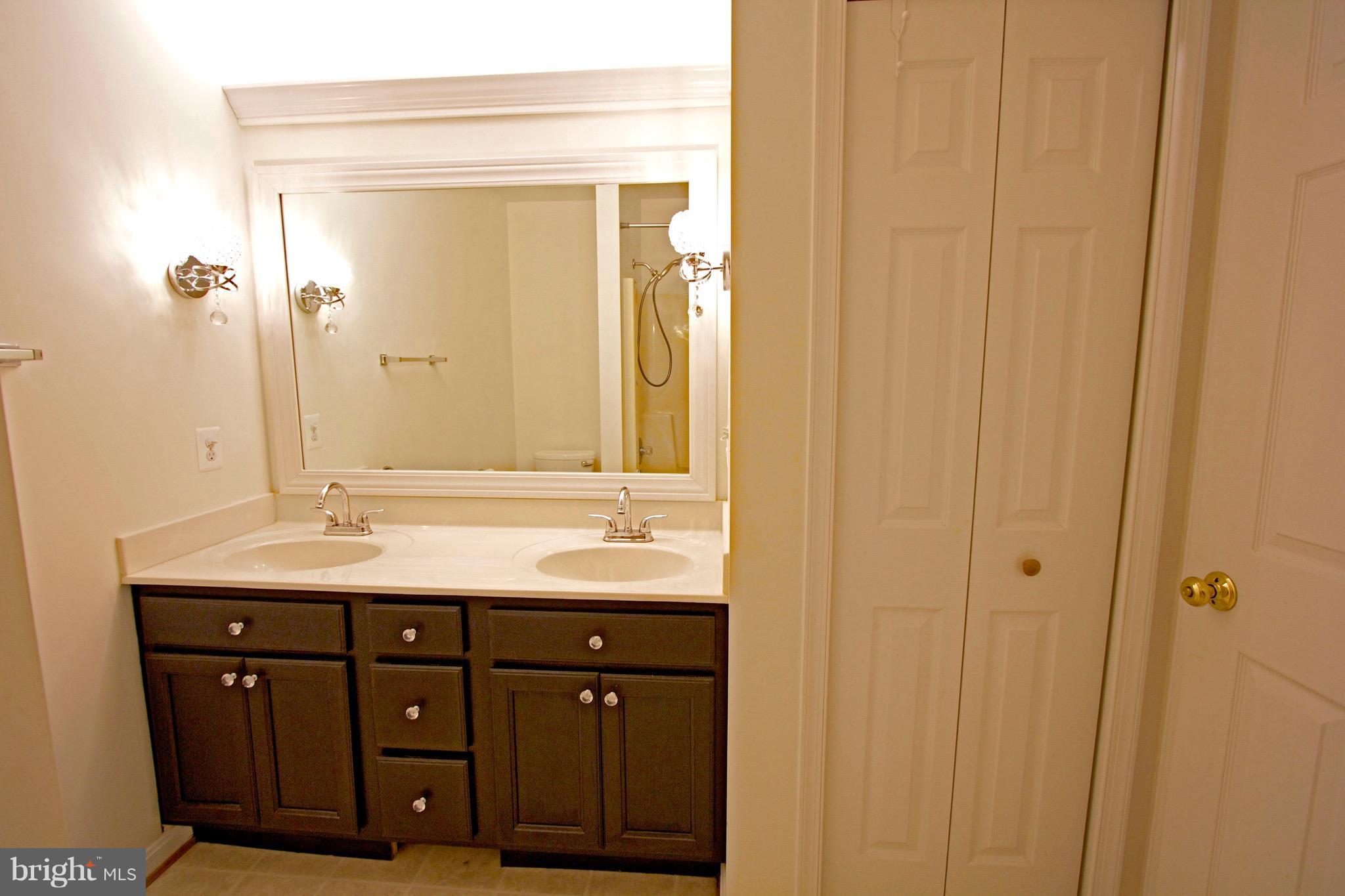 19955 Piney Point Road Callaway, MD 20620 - Photo 22 of 30 a bathroom with a granite countertop sink and a mirror