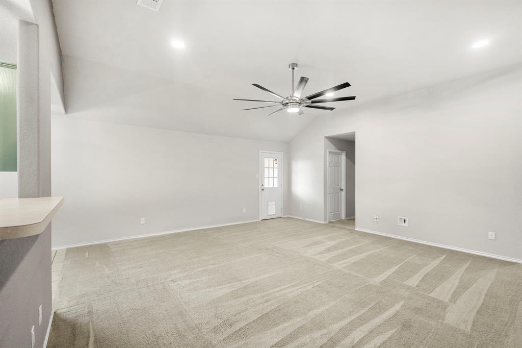 10620 Granada Drive Waco, TX 76708 - Photo 8 of 38 Vaulted ceiling with recessed lighting and a ceiling fan, light-colored carpeting, and a white paneled door