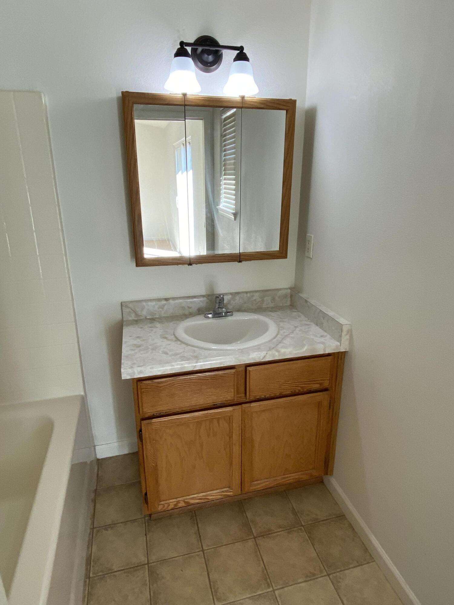 18602 Old Oasis Road Redding, CA 96003 - Photo 14 of 23 a bathroom with a granite countertop sink and a mirror