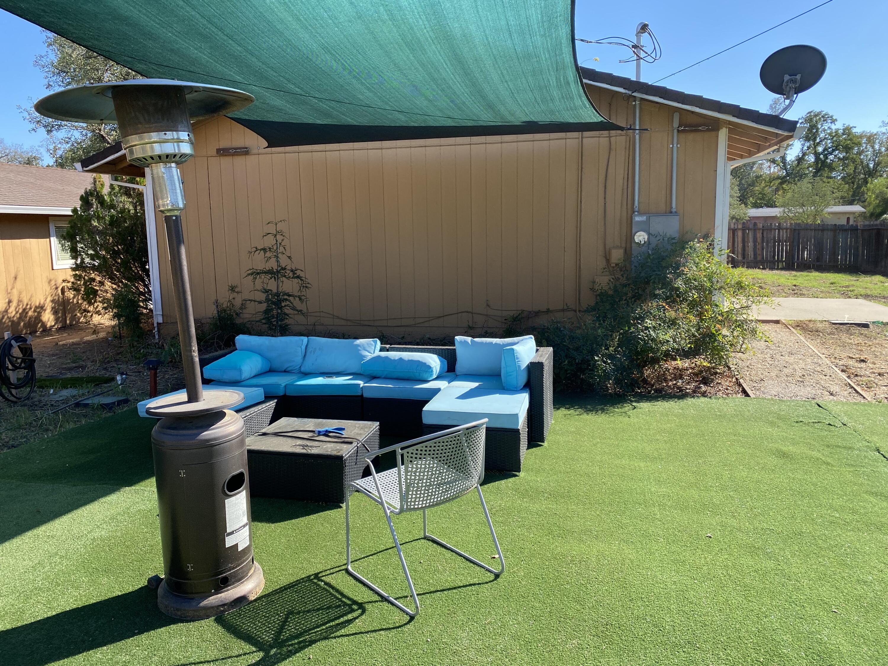 18602 Old Oasis Road Redding, CA 96003 - Photo 15 of 23 a backyard of a house with table and chairs under an umbrella