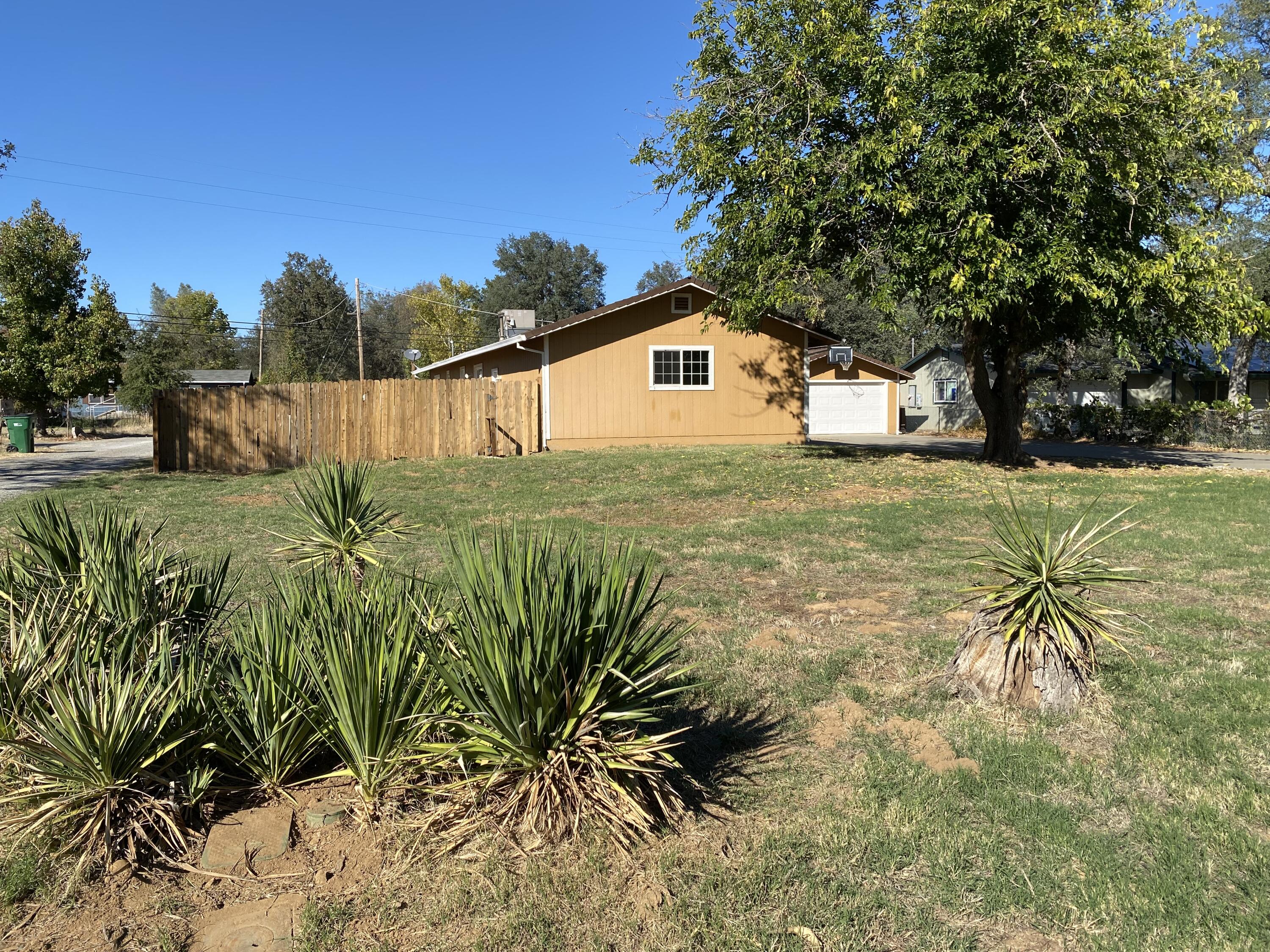 18602 Old Oasis Road Redding, CA 96003 - Photo 22 of 23 a backyard of a house with table and chairs