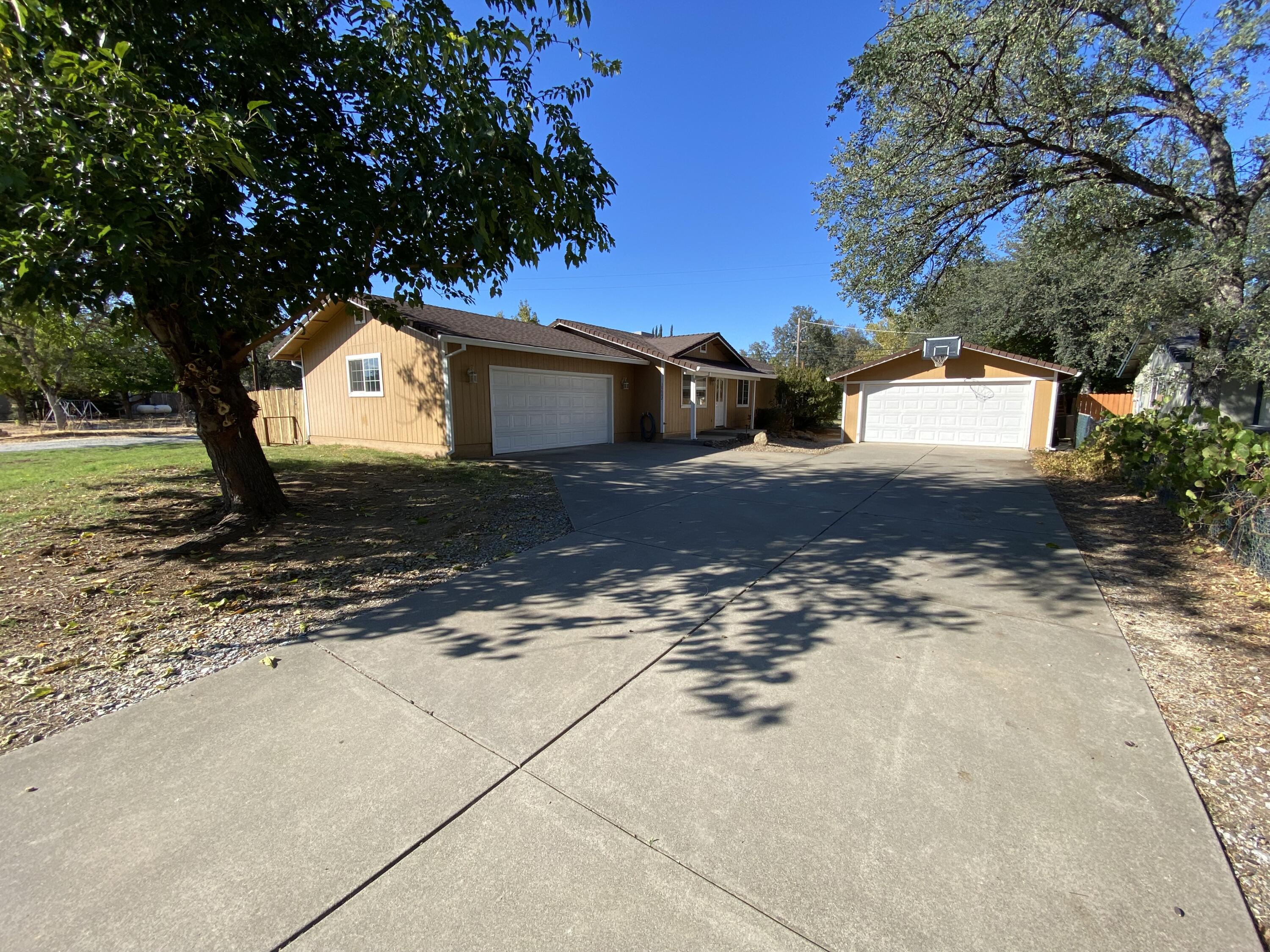 18602 Old Oasis Road Redding, CA 96003 - Photo 23 of 23 a view of a yard with a tree in the background