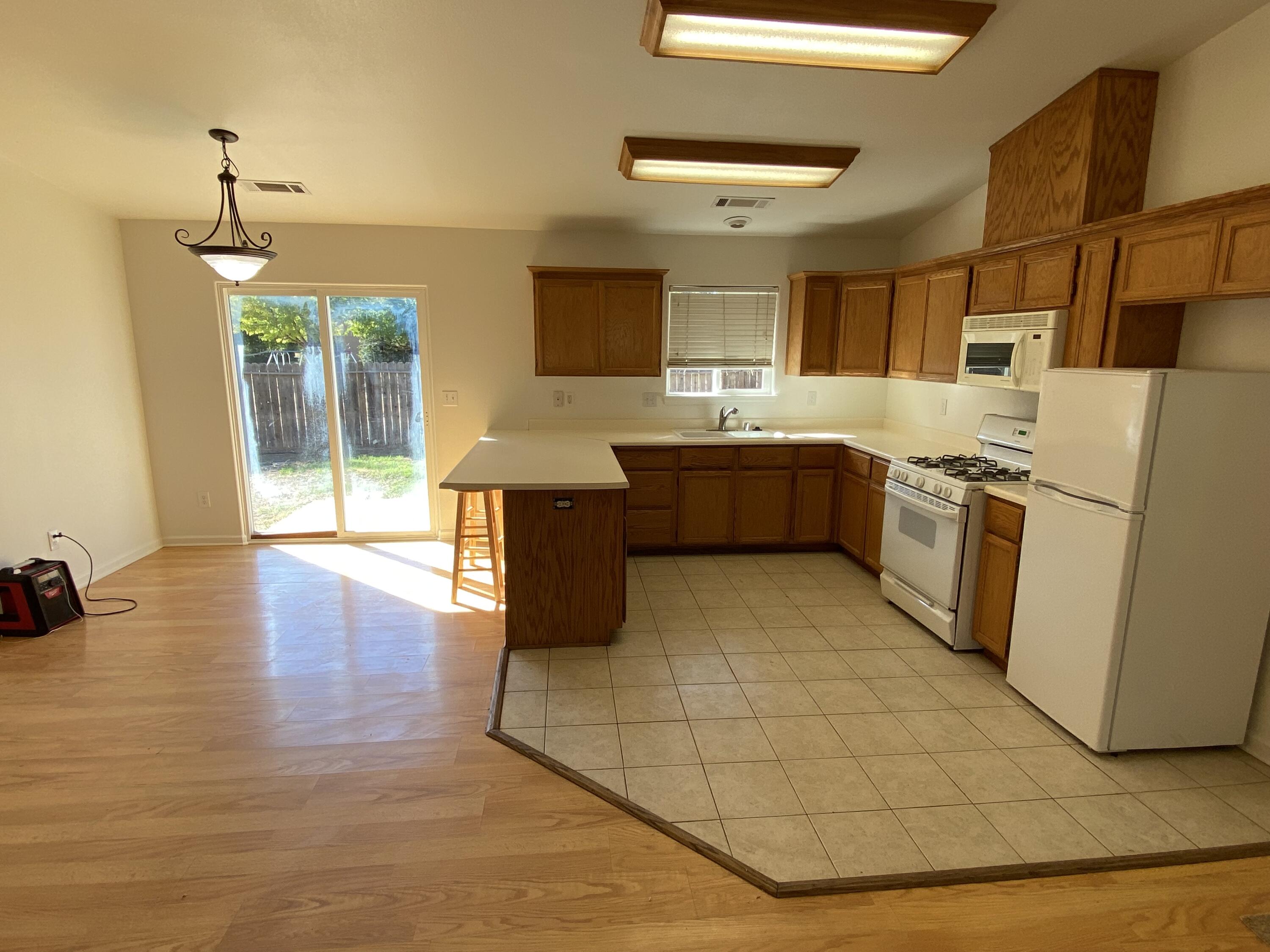 18602 Old Oasis Road Redding, CA 96003 - Photo 3 of 23 a large kitchen with stainless steel appliances granite countertop a stove a sink dishwasher and a refrigerator