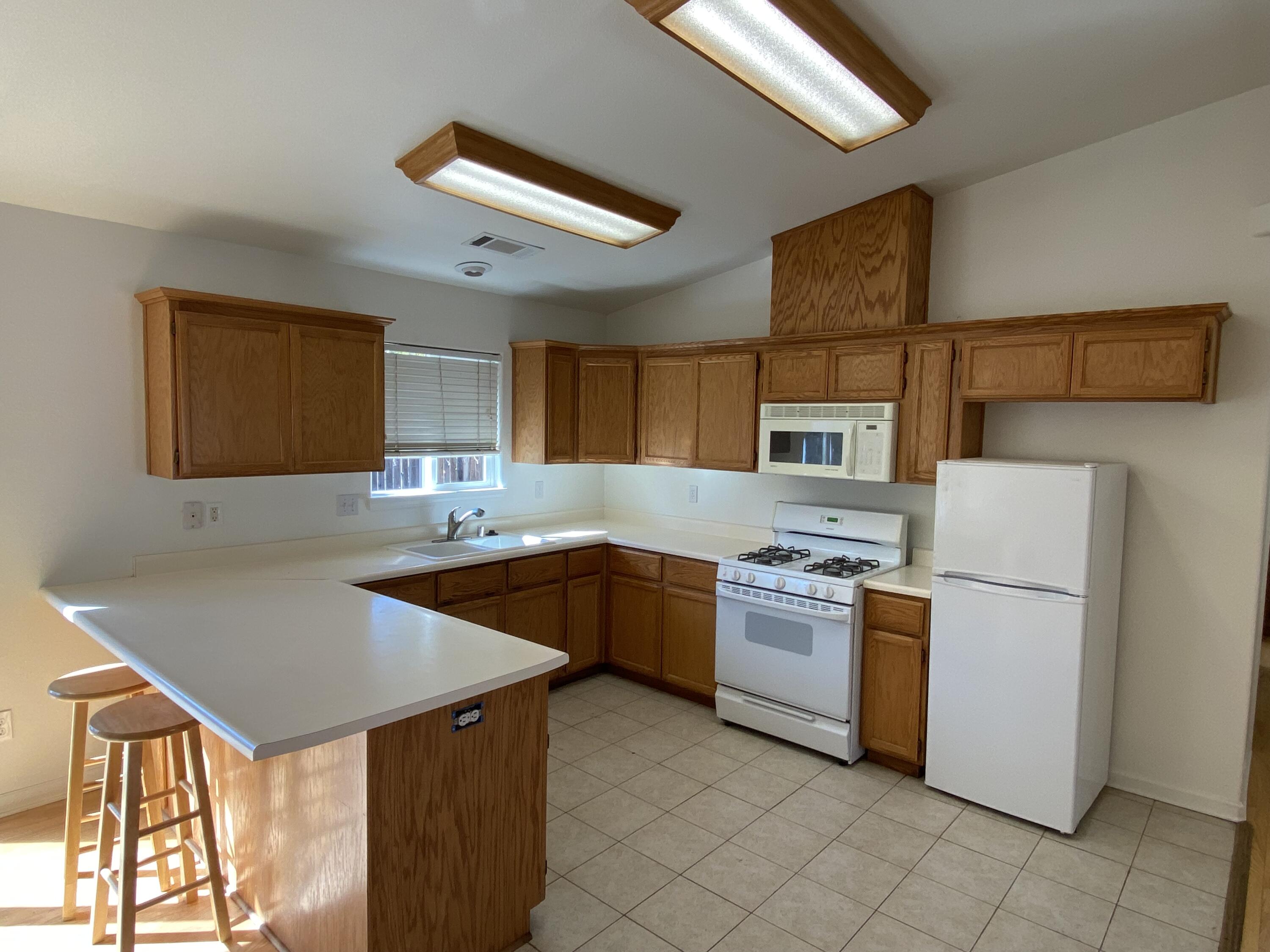 18602 Old Oasis Road Redding, CA 96003 - Photo 4 of 23 a kitchen with a stove a sink and a refrigerator