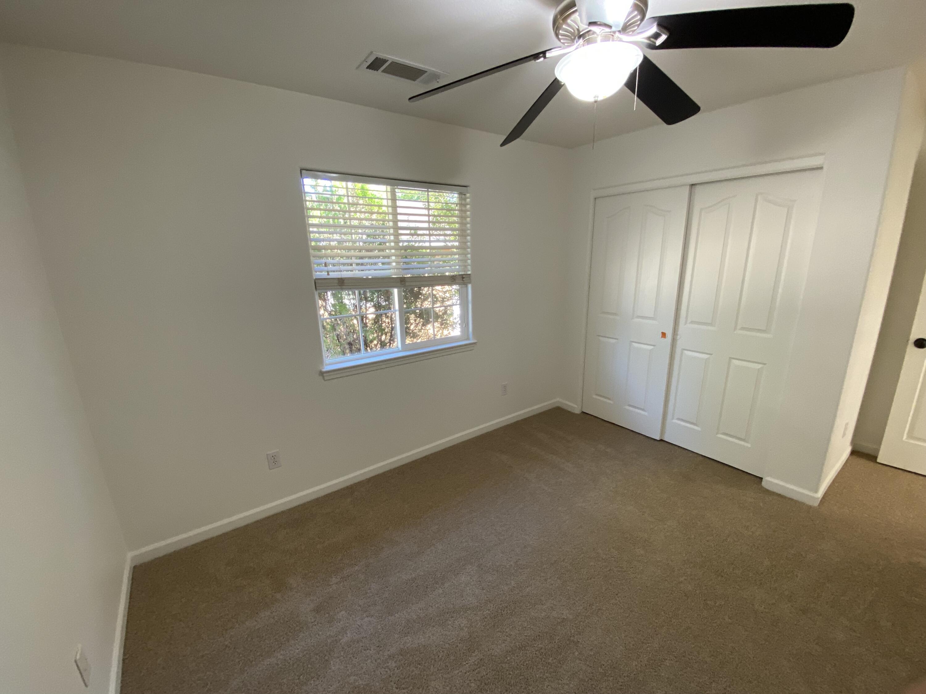 18602 Old Oasis Road Redding, CA 96003 - Photo 8 of 23 en empty room with windows and fan