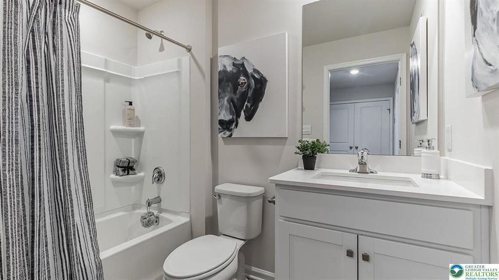 1145 Martin Road Breinigsville, PA 18031 - Photo 22 of 38 A well-appointed bath features a tub, shower, and a clean vanity with ample counter space.