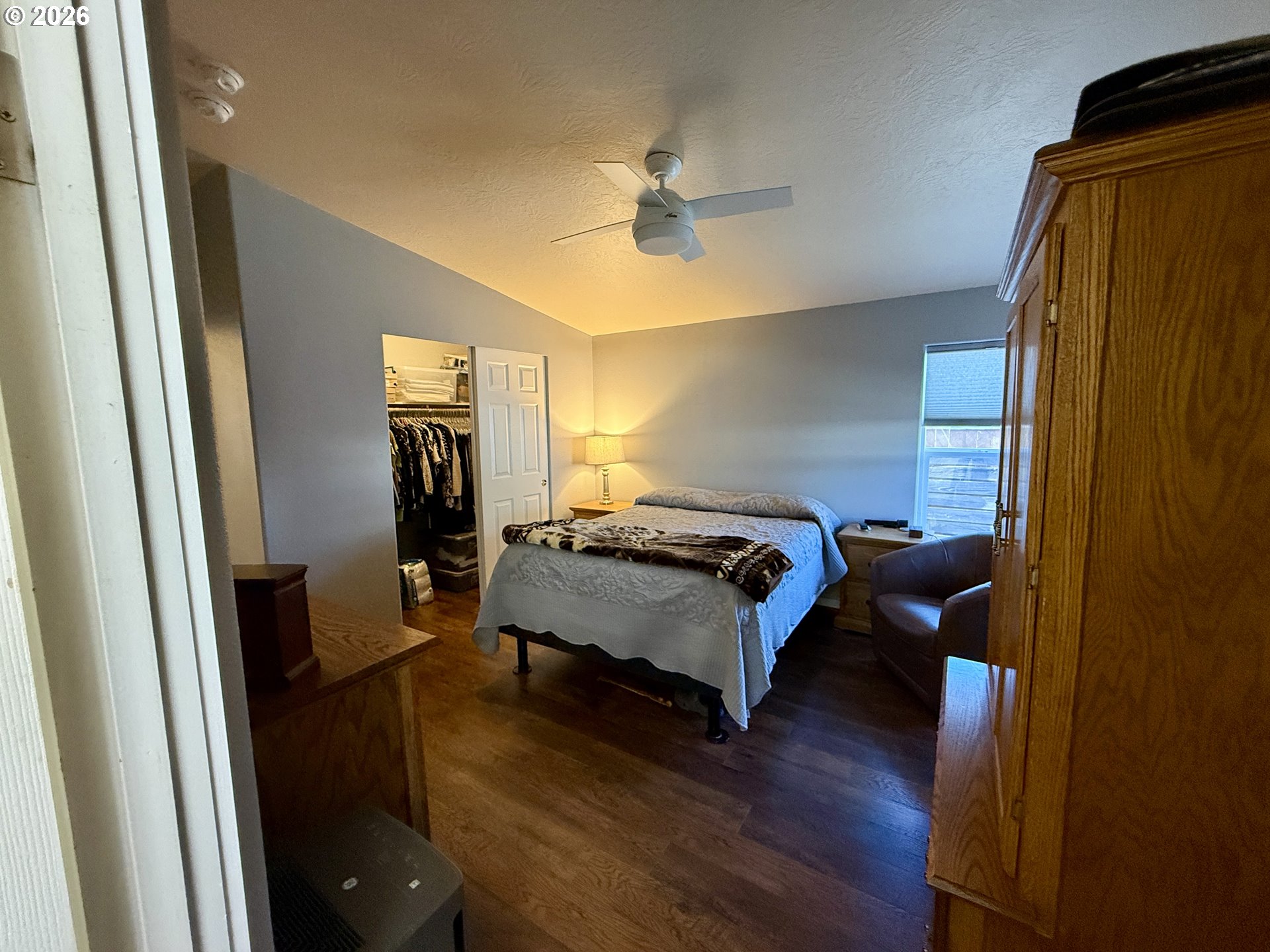 3050 Knott Terrace Coos Bay, OR 97420 - Photo 12 of 24 a bedroom with a bed and wooden floor