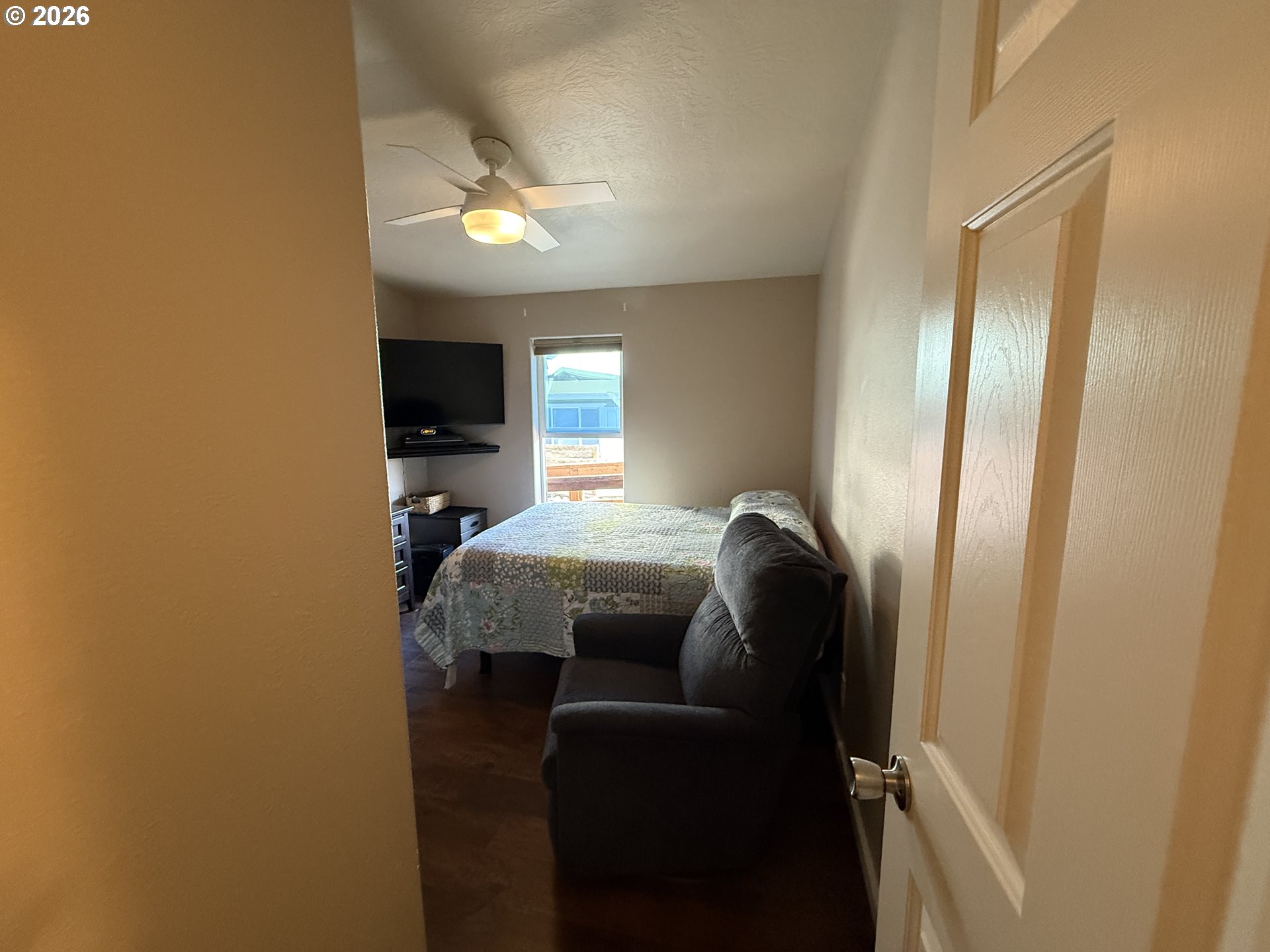 3050 Knott Terrace Coos Bay, OR 97420 - Photo 17 of 24 a bedroom with a bed and a chandelier